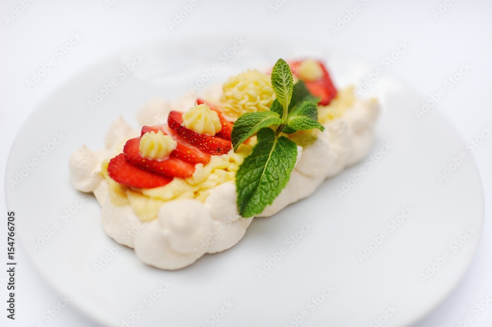 Dessert with strawberries and mint on a bise closeup Dessert with strawberries and mint on a bise closeup