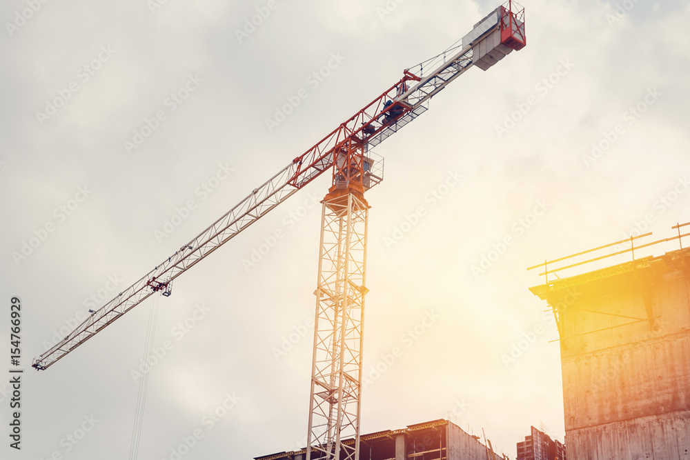 Lifting crane. Concept building of new houses from combined materials. Flare, sun. Lifting crane. Concept building of new houses from combined materials. Flare, sun.