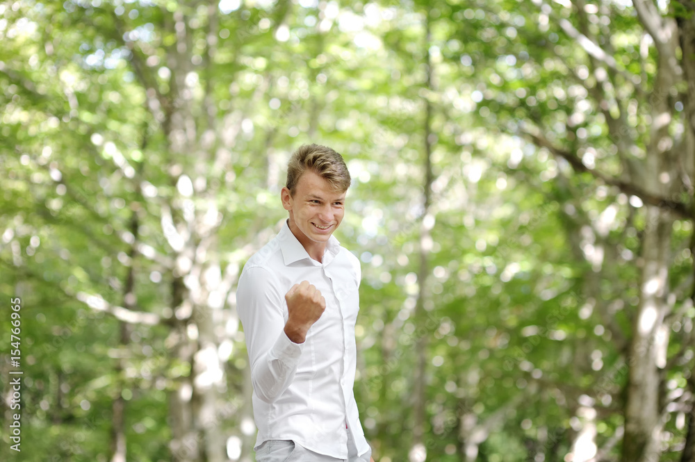 Happy young man celebrating success Happy young man celebrating success