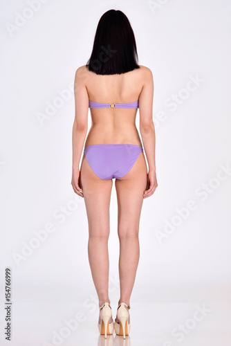 Woman in underwear full lengh back side