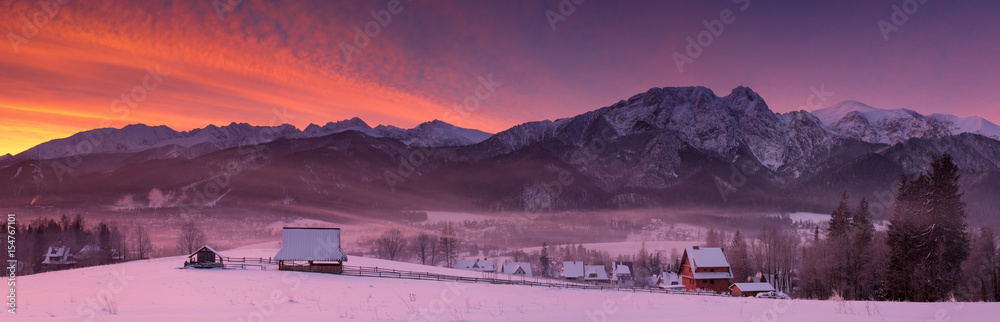 Naklejka premium View At Most Famous Polish Ski Resort Zakopane From The Top Of Gubalowka, Against The Background Of Snow-Capped Peaks High Tatras Mountains. Winter Landscape Of Poland Tatra Mountains & Giewont Peak