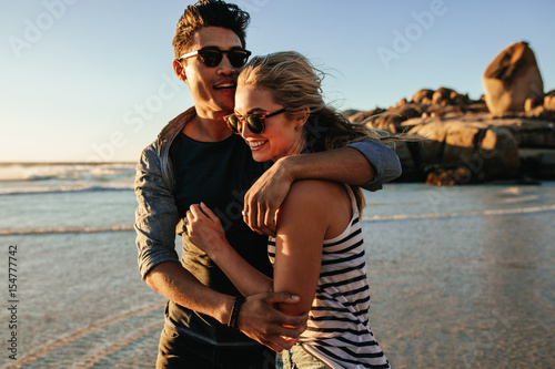 Young man and woman in love on seashore
