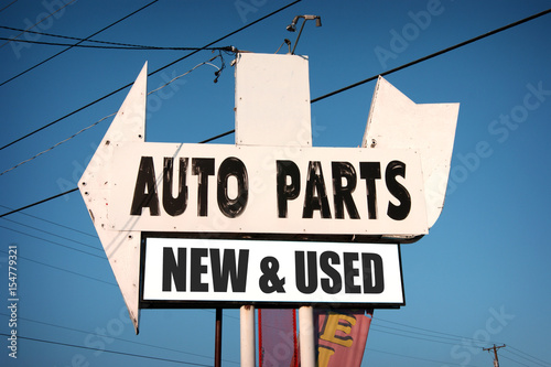 new and used auto parts sign