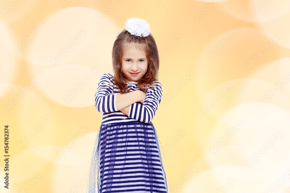Cute little girl posing in front of the camera.