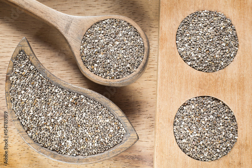 Chia seeds in the wooden bowl - Salvia hispanica