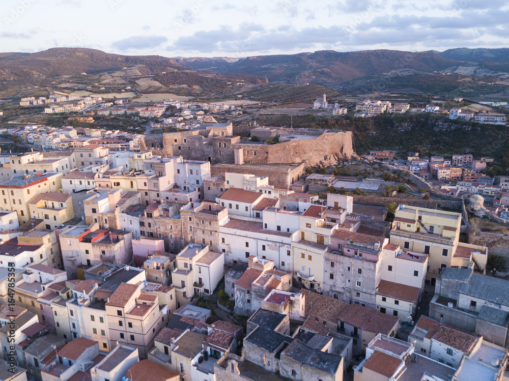 Aerial view of an Italian city on the coast of Sardinia at sunset. Castelsardo, Sardinia, Italy.