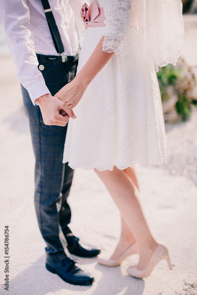 bride and groom holding hands together bride and groom holding hands together