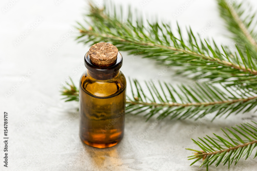 aromatherapy with organic spruce oils in glass bottles on white table background