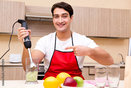 Handsome man working at the kitchen photo