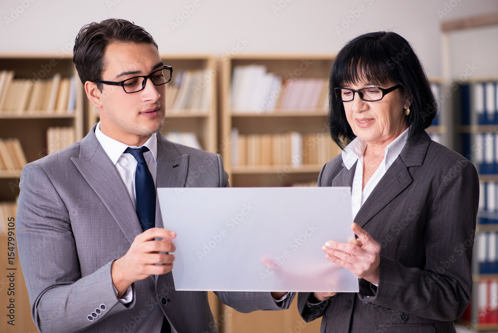 Business couple discussing business results on tablet Business couple discussing business results on tablet
