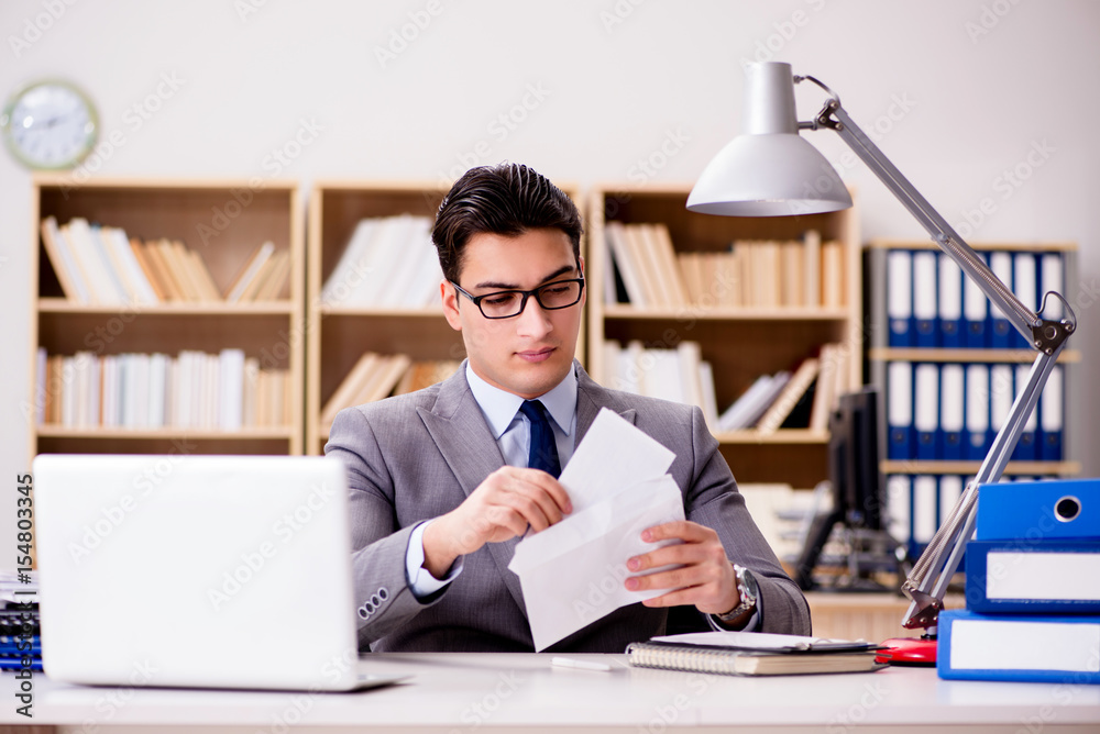 Businessman receiving letter envelope in office Businessman receiving letter envelope in office