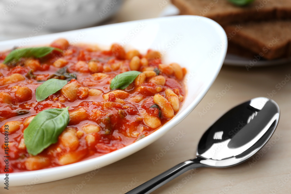 Plate with delicious Italian butter beans and spoon, close up Plate with delicious Italian butter beans and spoon, close up