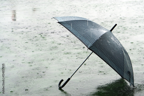 Принти на полотні Umbrella on rainy day - The raindrops falling on an umbrella which put on the ground, make me so lonely