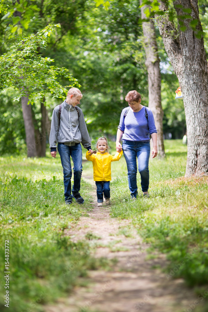 Obraz premium Grandmother is walking with her grandchildren