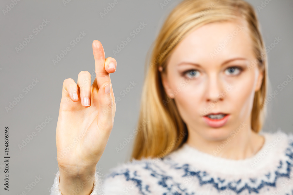 Teenage blonde woman making promise gesture Teenage blonde woman making promise gesture
