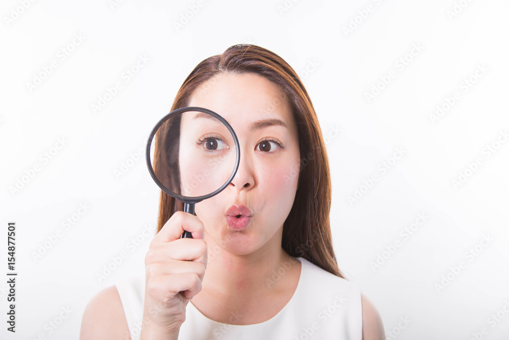 Young woman looking through a magnifying glass on a white background Young woman looking through a magnifying glass on a white background