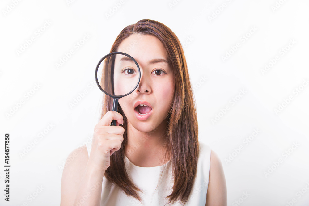 Young woman looking through a magnifying glass on a white background Young woman looking through a magnifying glass on a white background