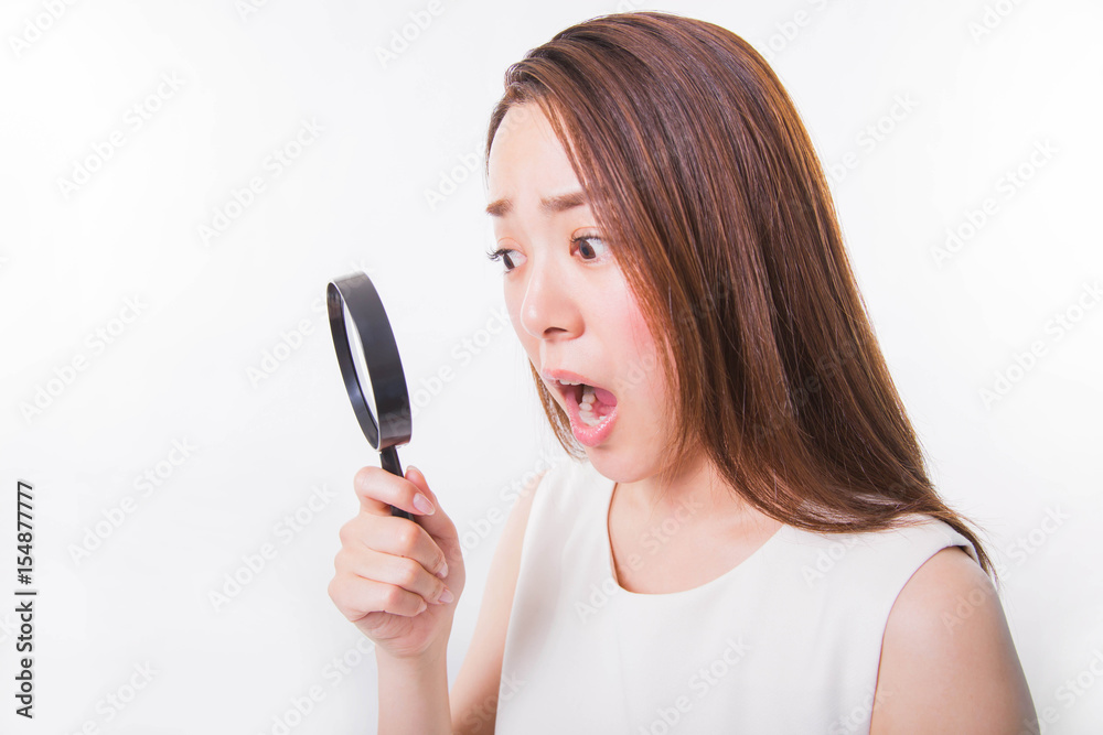 Young woman looking through a magnifying glass on a white background Young woman looking through a magnifying glass on a white background