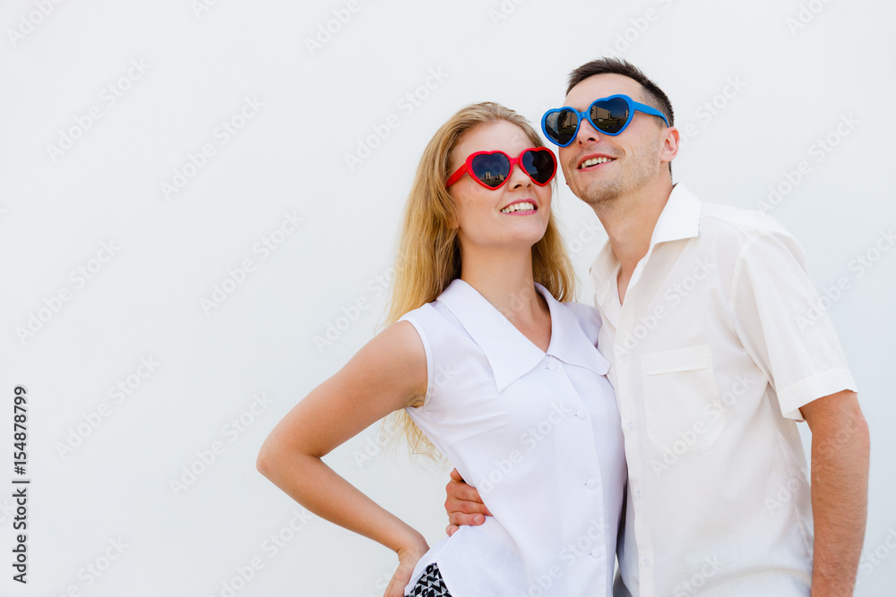 Man and woman wearing heart shape sunglasses Man and woman wearing heart shape sunglasses