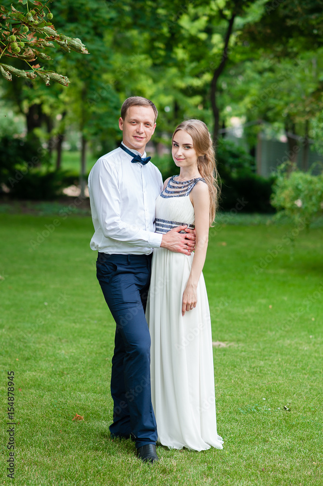 A married couple is walking and hugging in the park. A married couple is walking and hugging in the park.