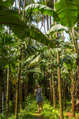 Young woman in the jungle in tropical spice plantation, Goa, India
