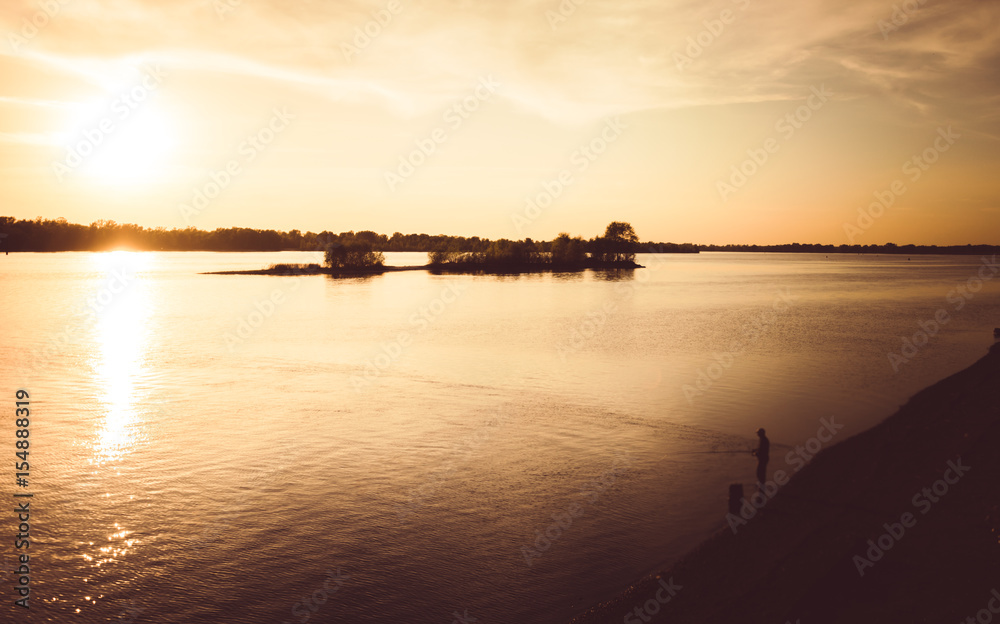 Fishing at sunset. A picturesque sunset over the Dnieper River