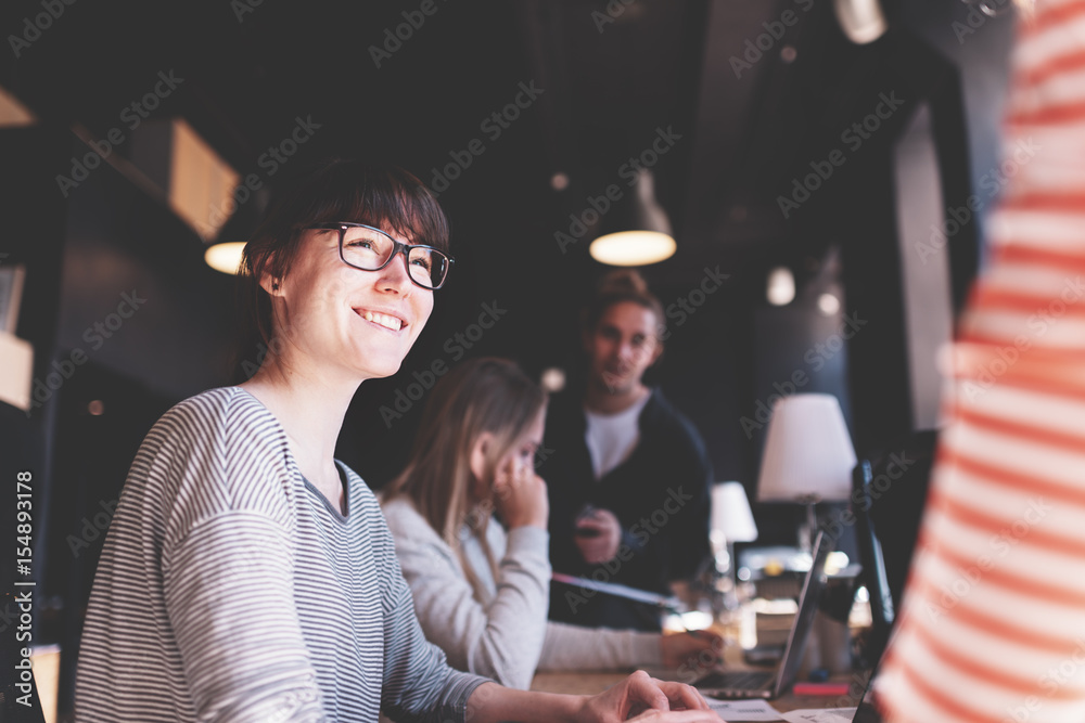 Portrait of young woman manager. Group of business people working together in office. Marketing department discussing product strategy Portrait of young woman manager. Group of business people working together in office. Marketing department discussing product strategy
