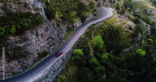 red sport convertible car moving in Amalfi coast