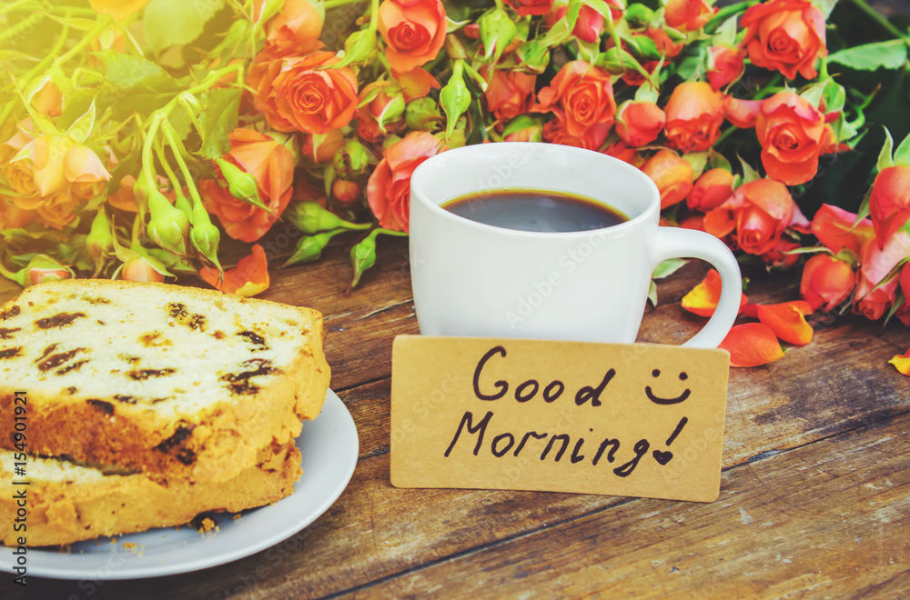 A Cup of coffee for Breakfast. Good morning. Flowers. Selective focus