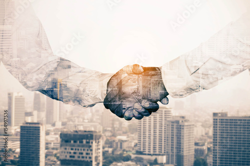 Business people shake hands.