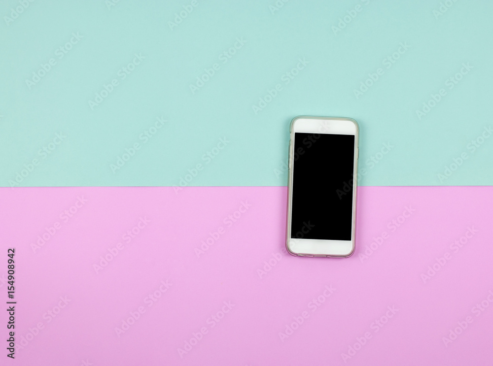 blank smart phone on blue and pink background. flat lay, top view.