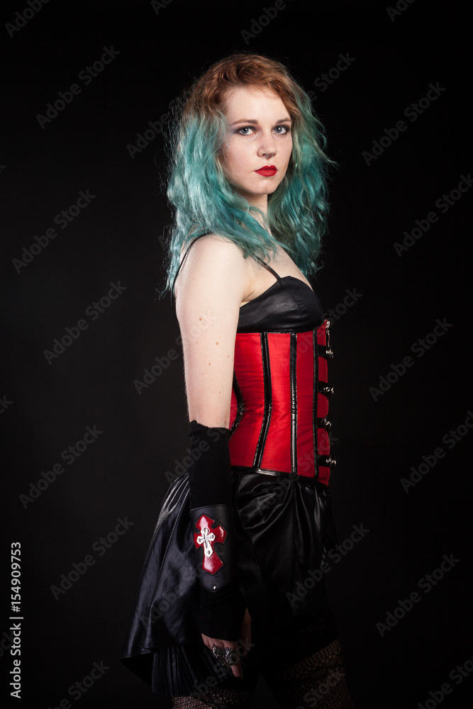 Slim woman in fetish red leather corset on black background in studio  photo. BDSM and dominatrix foto de Stock | Adobe Stock