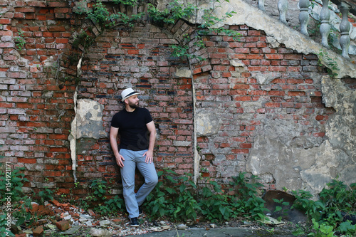 Fototapeta Naklejka Na Ścianę i Meble -  old brick wall man stand