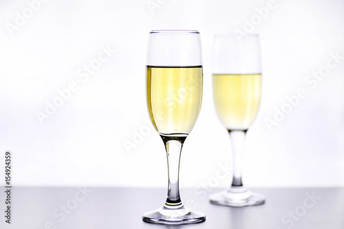 glass of white wine on a table on white background isolate