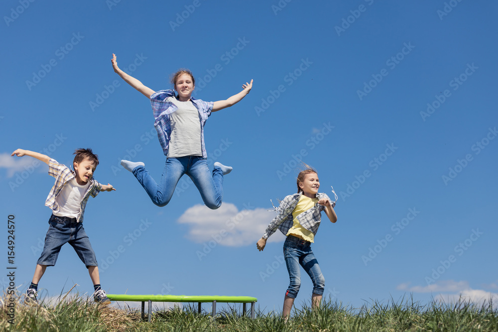 Brother and sisters playing on the field at the day time. Brother and sisters playing on the field at the day time.