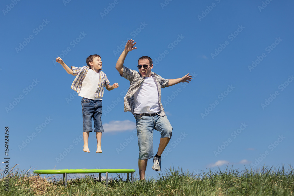 Father and son playing on the field at the day time. Father and son playing on the field at the day time.