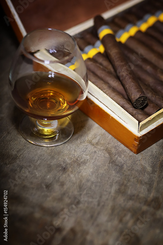 Large box of Cuban cigars on a wooden table