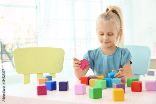 Cute little girl playing wi...