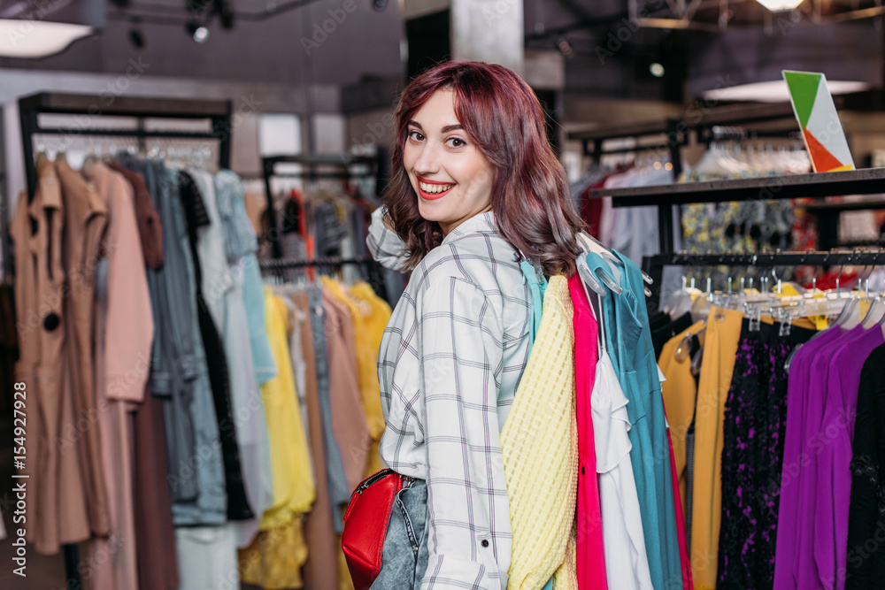 young hipster girl smiling in boutique, clothes shopping concept young hipster girl smiling in boutique, clothes shopping concept
