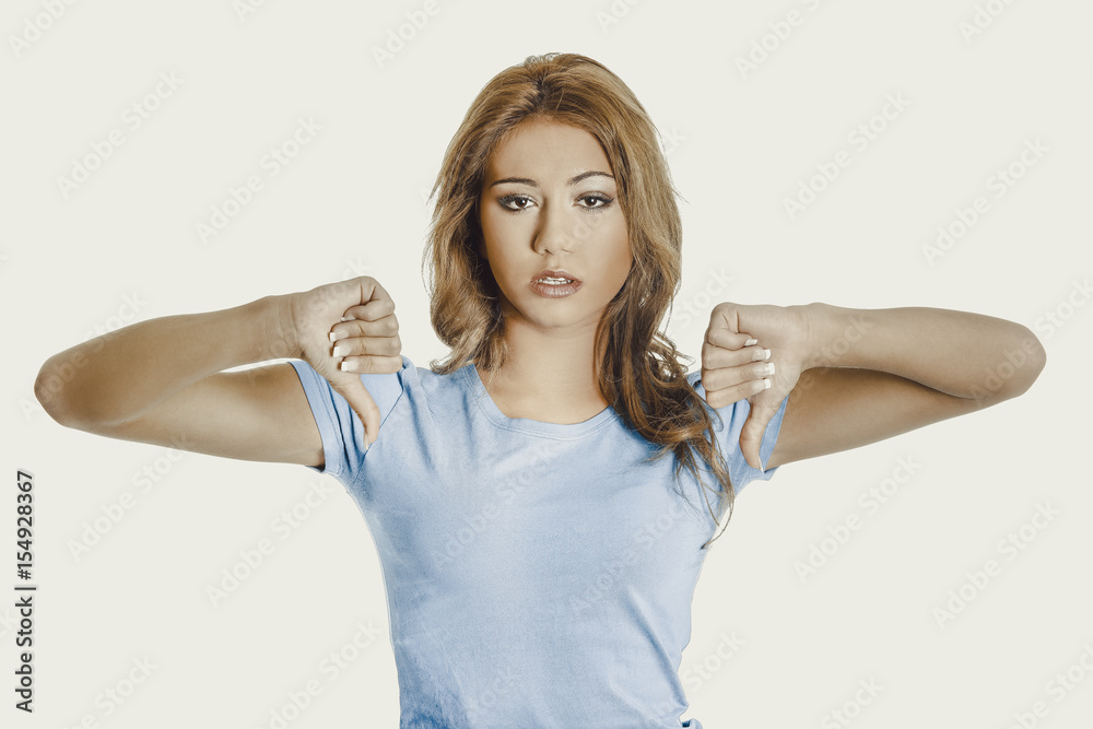 Young woman with thumbs down. Young woman with thumbs down.