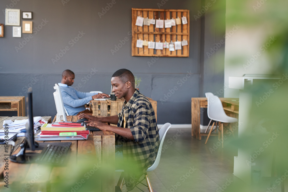 Fototapeta premium Focused African businessmen hard at work in a modern office
