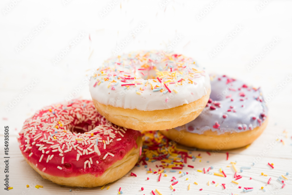 Close Up view of three tasty donuts with frosting on the top