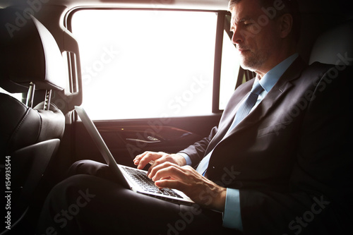 businessman with notebook sitting inside an airplane © opolja