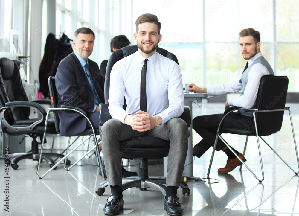 Fototapeta premium Happy smart business man with team mates discussing in the background.