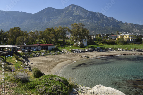 Bay with a beach near Lapta village with clear blue water and blue sky photo