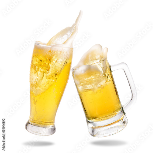 Cheers cold beer with splashing out of glasses on white background.