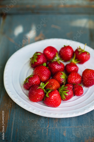 Ripe strawberries in a plate  rustic