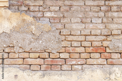 Big wall of old cracked brick background