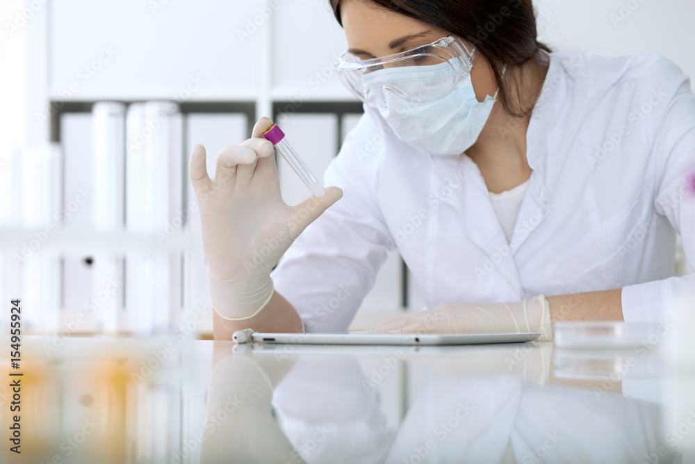 Close up of scientific research hands with clear solution in laboratory Close up of scientific research hands with clear solution in laboratory