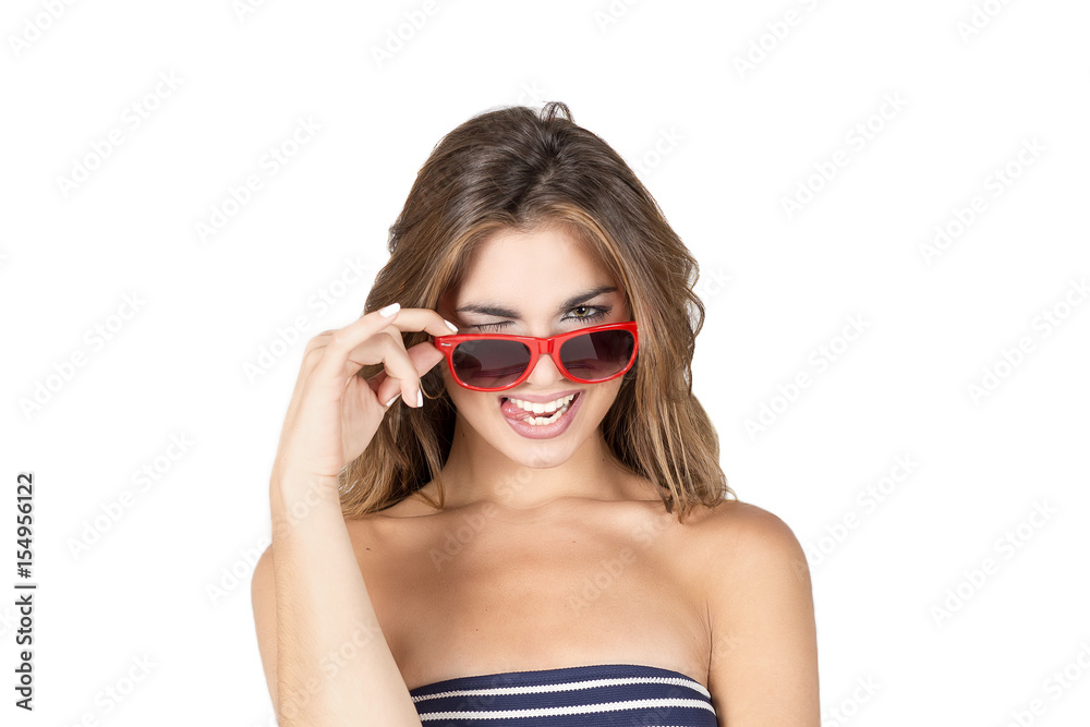 Beautiful young woman with blond hair and red sunglasses with funny face